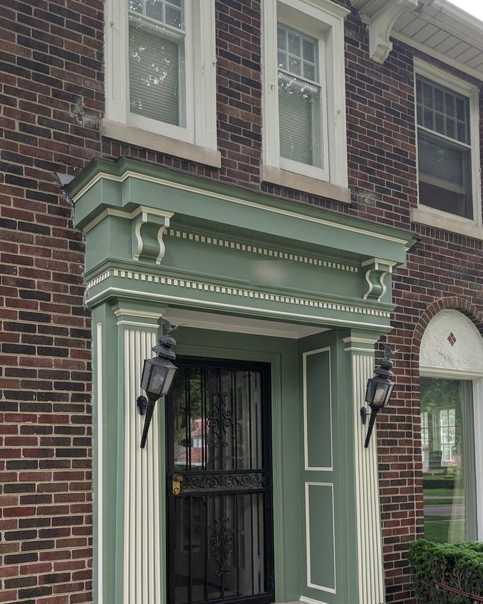 The same entryway repainted sage green with cream detailing