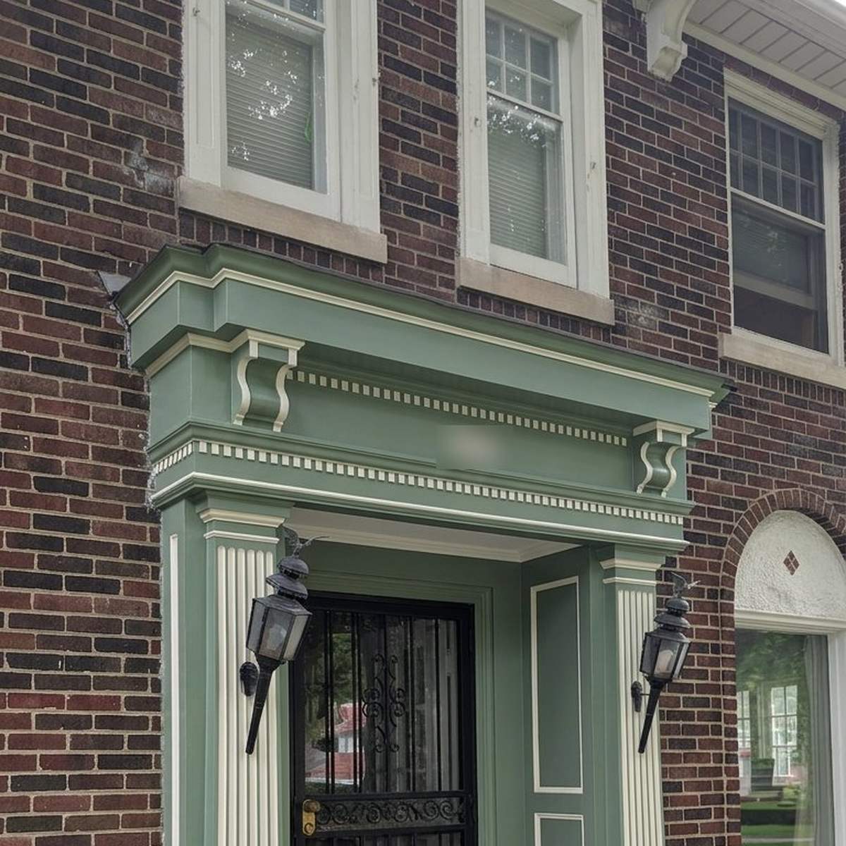 Entryway surround repainted sage green with cream detailing