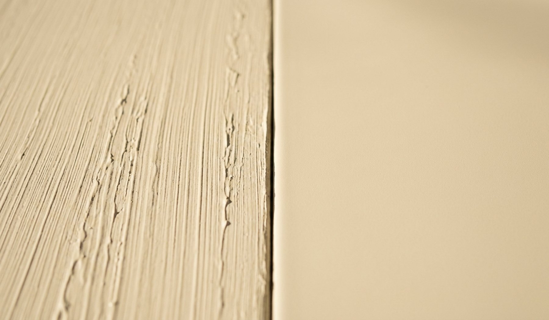 Brush stroke texture on one half of a panel beside a smooth sprayed finish on the other